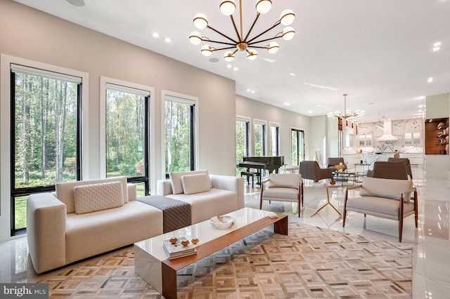 living room featuring a notable chandelier and light parquet floors