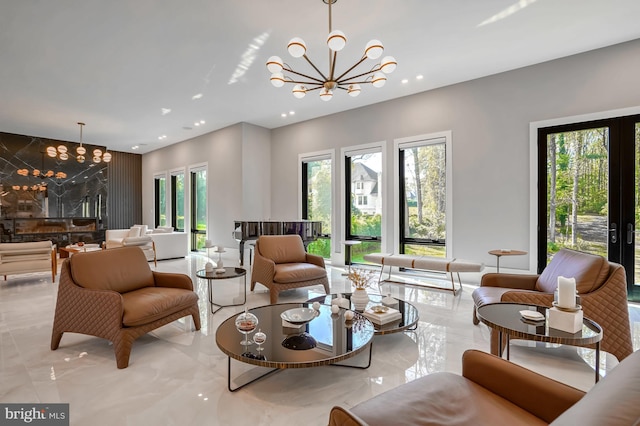 living room featuring french doors and a notable chandelier