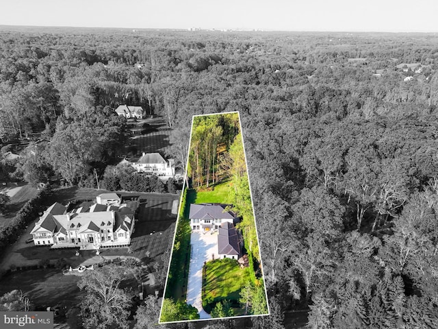 drone / aerial view featuring a forest view