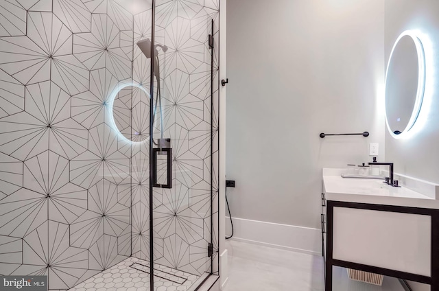 bathroom featuring vanity, a shower with shower door, and tile patterned floors