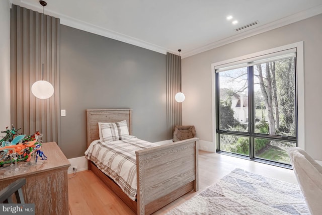 bedroom with ornamental molding and light wood-type flooring