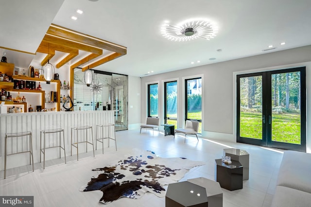 tiled living room with bar and french doors