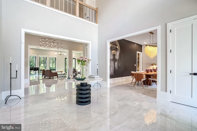 foyer entrance with a high ceiling and an inviting chandelier