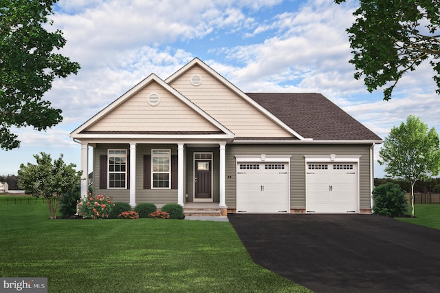 view of front of home with a garage, covered porch, and a front yard