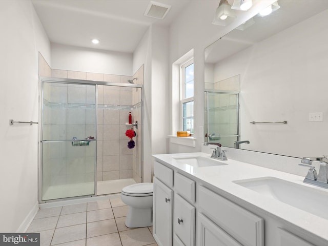 bathroom with walk in shower, tile patterned floors, vanity, and toilet