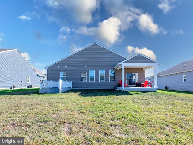 rear view of property with a lawn