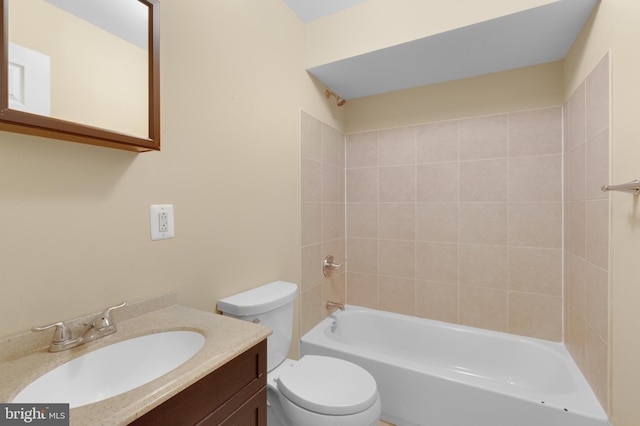 full bathroom with toilet, tiled shower / bath, and vanity