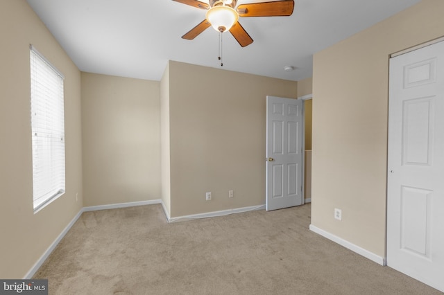 empty room with light carpet and ceiling fan