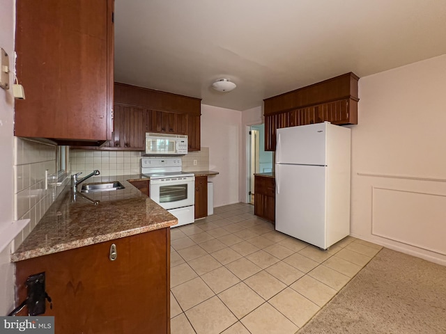 kitchen featuring white appliances, sink, light tile patterned floors, and tasteful backsplash