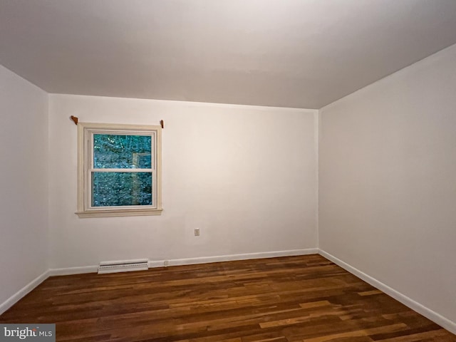 empty room with dark wood-type flooring