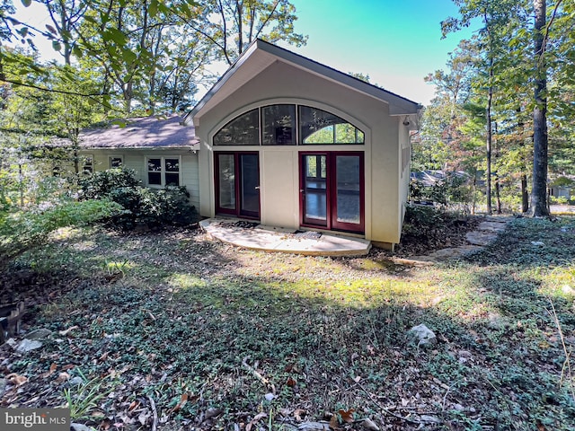 rear view of property with french doors