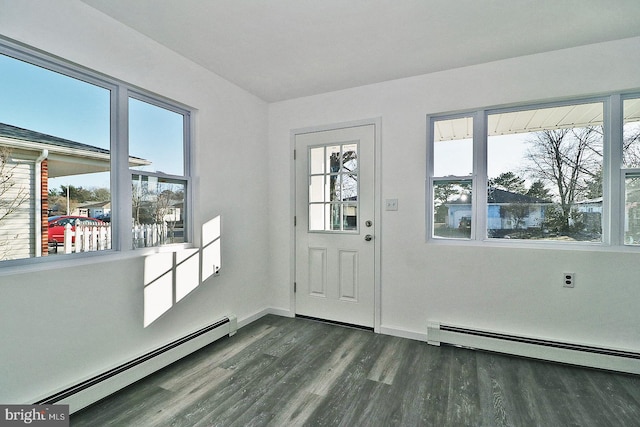 doorway featuring a baseboard heating unit, dark wood-style flooring, and a healthy amount of sunlight