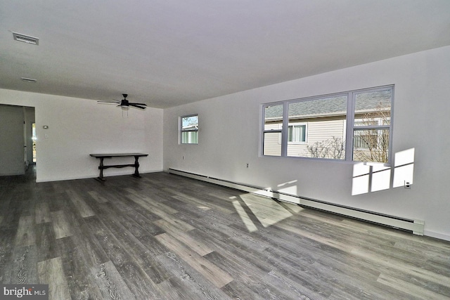 unfurnished room featuring a baseboard radiator, visible vents, ceiling fan, and wood finished floors