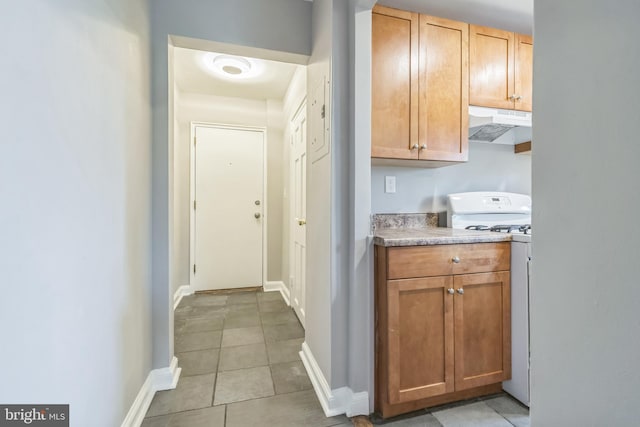 kitchen with light tile patterned floors and white range oven