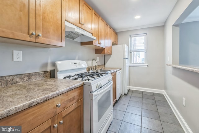 kitchen with sink, white appliances, and light tile patterned floors