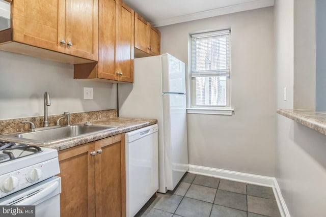 kitchen featuring white appliances, tile patterned floors, sink, and ornamental molding