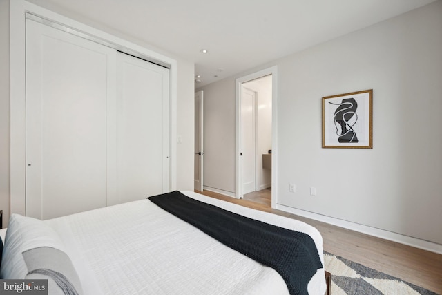 bedroom featuring a closet and light hardwood / wood-style floors