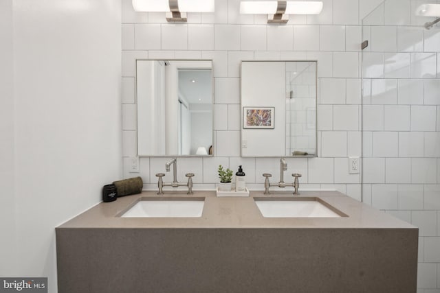 bathroom with vanity, backsplash, and tile walls