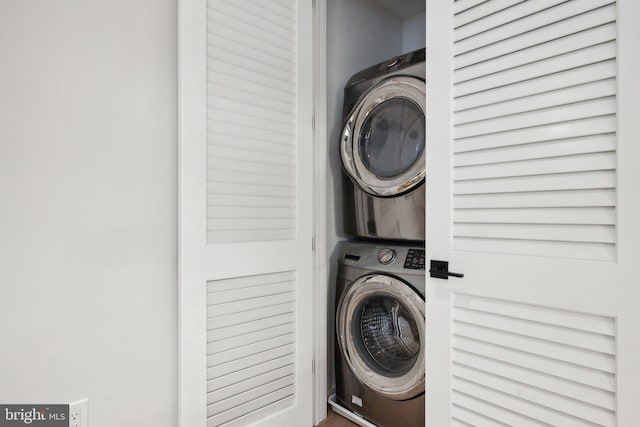 clothes washing area with stacked washer and clothes dryer