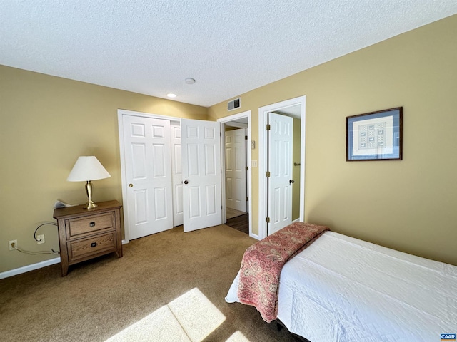 bedroom featuring a closet, carpet, and a textured ceiling