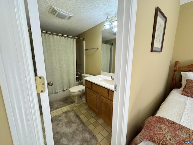 full bathroom with vanity, shower / bath combo, a textured ceiling, tile patterned floors, and toilet