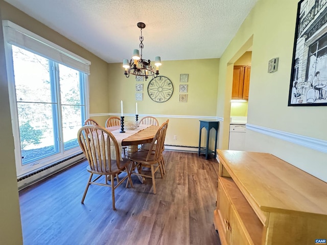 dining room with an inviting chandelier, dark hardwood / wood-style floors, a baseboard radiator, and a textured ceiling