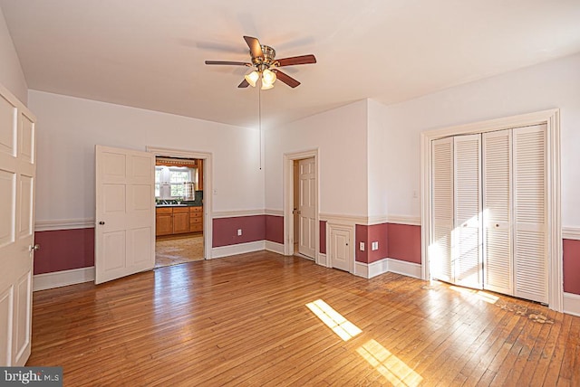 interior space with ceiling fan and hardwood / wood-style flooring