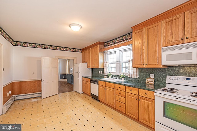 kitchen with sink, white appliances, and tasteful backsplash