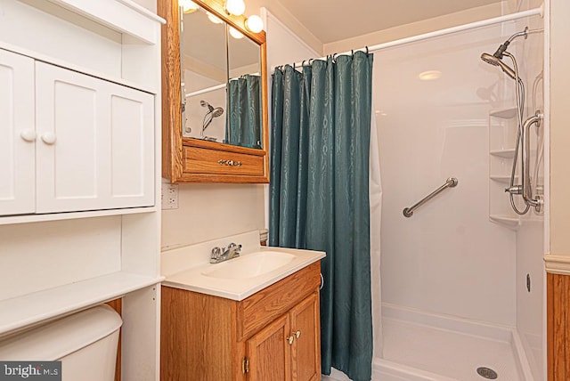 bathroom featuring toilet, vanity, and a shower with shower curtain