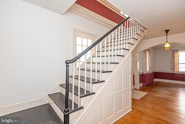 stairs featuring hardwood / wood-style floors