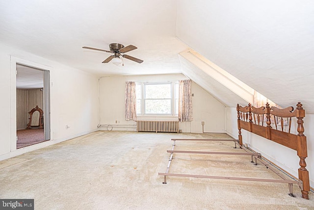 bonus room featuring carpet flooring, vaulted ceiling, radiator heating unit, and ceiling fan