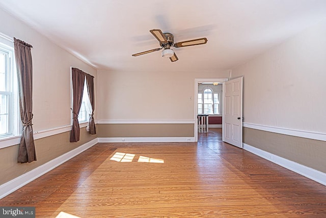 spare room featuring wood-type flooring and ceiling fan