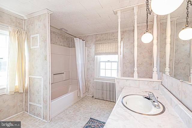 bathroom with vanity, ornamental molding, radiator heating unit, and shower / bath combo