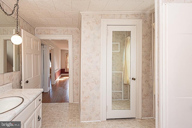 bathroom featuring vanity, crown molding, hardwood / wood-style flooring, and a shower with shower curtain