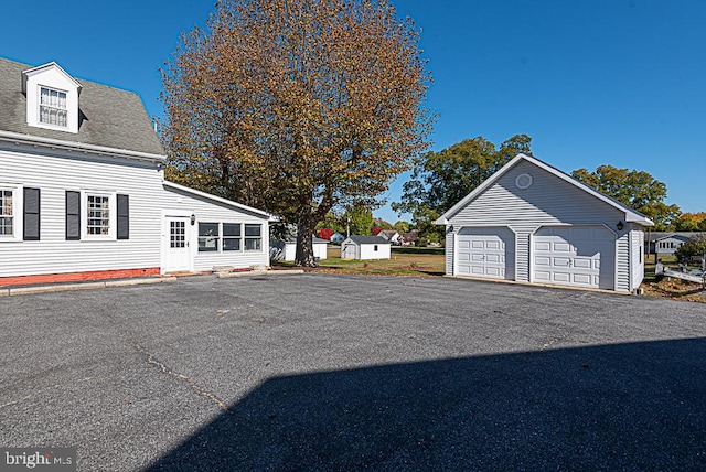 view of home's exterior featuring an outbuilding and a garage