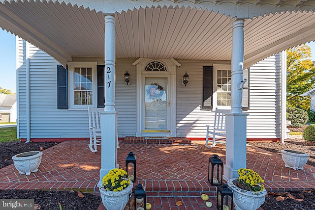 view of exterior entry featuring a porch