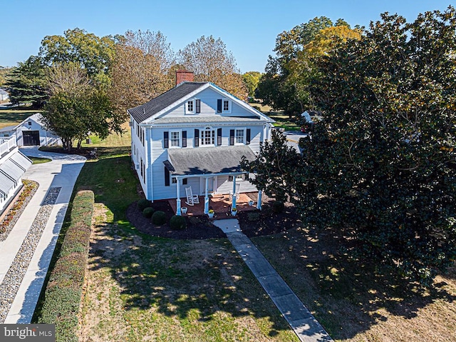 view of front of property with a porch and a front lawn