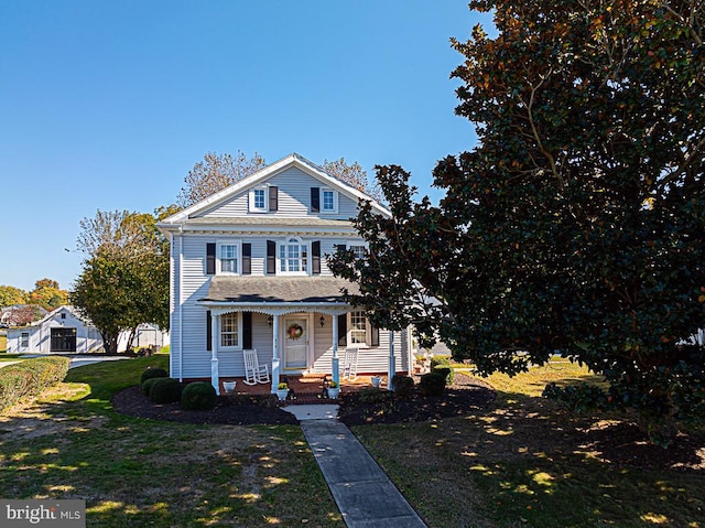 view of front of property with a front yard and covered porch