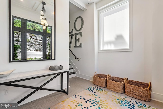 entryway featuring beam ceiling and light wood-type flooring