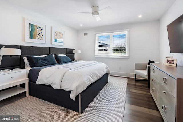 bedroom with ceiling fan and dark wood-type flooring