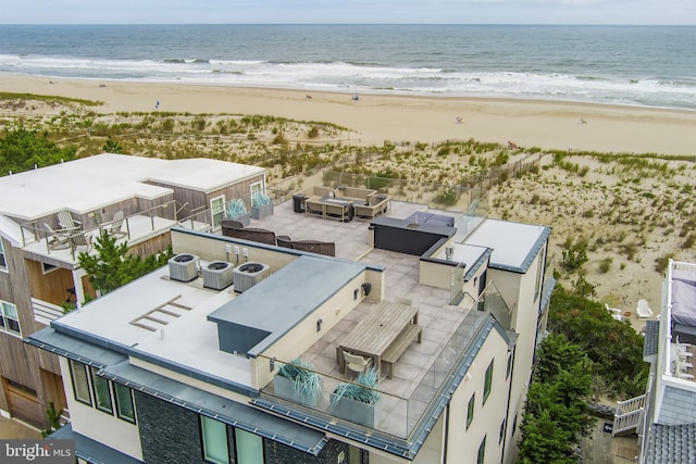 drone / aerial view with a water view and a view of the beach