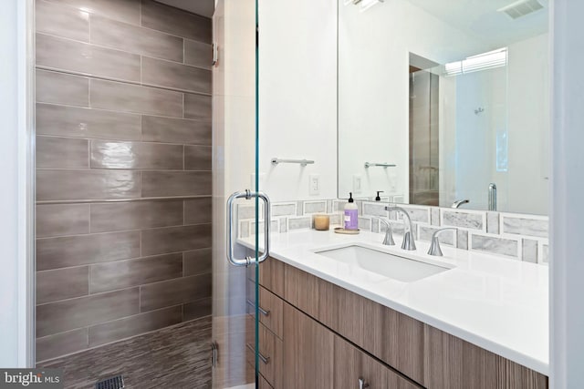 bathroom featuring vanity and a shower with door