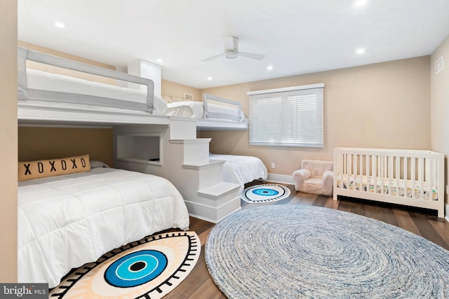 bedroom with ceiling fan and dark wood-type flooring