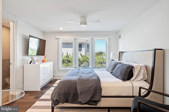 bedroom featuring multiple windows, dark wood-type flooring, and ceiling fan