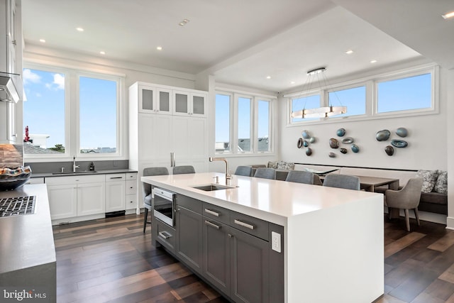 kitchen with white cabinets, a wealth of natural light, and sink