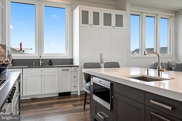 kitchen featuring white cabinetry, sink, and a wealth of natural light