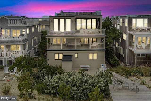 view of back house at dusk