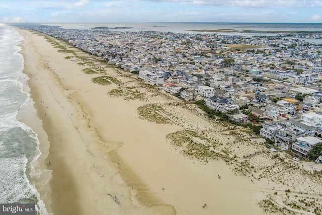 drone / aerial view featuring a view of the beach and a water view