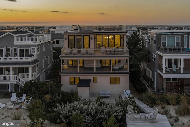 view of back house at dusk