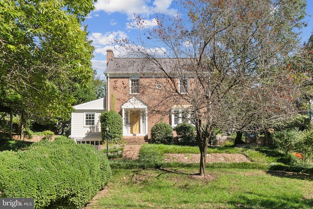 colonial home with a front yard